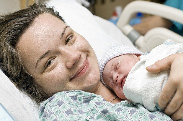newborn-baby-and-smiling-mom resized